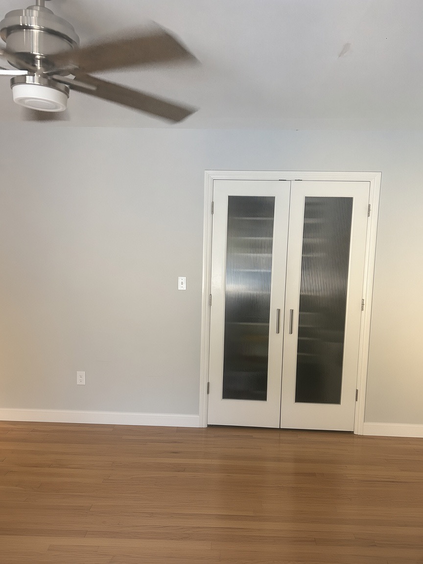 White double closet doors with frosted glass panels in a bedroom